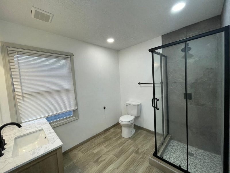 a bathroom with a shower toilet and a sink