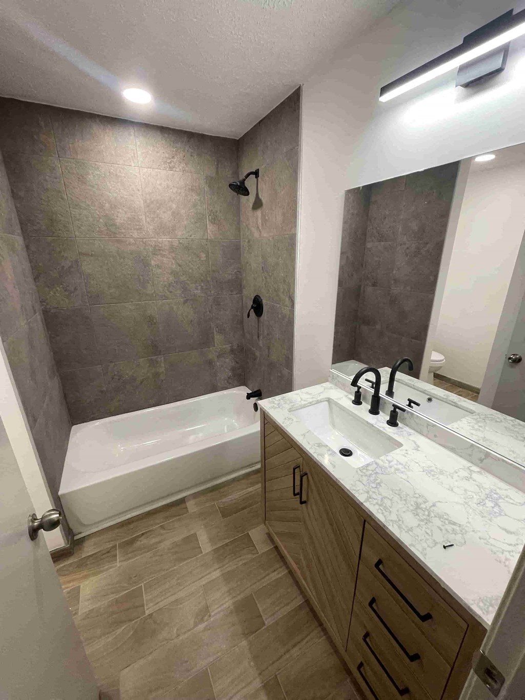 a bathroom with a sink and a shower and a tub