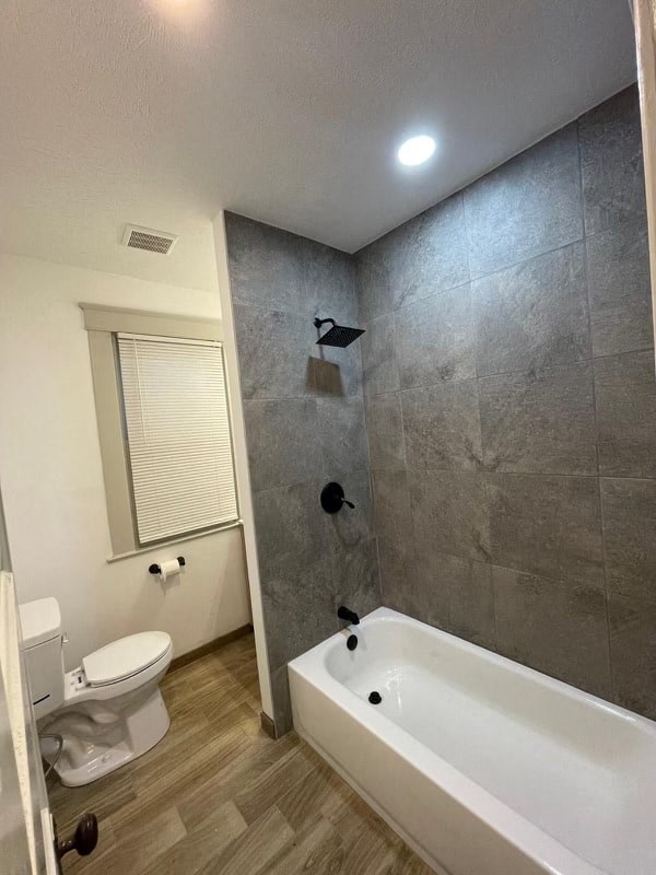 a bathroom with a bath tub and a toilet