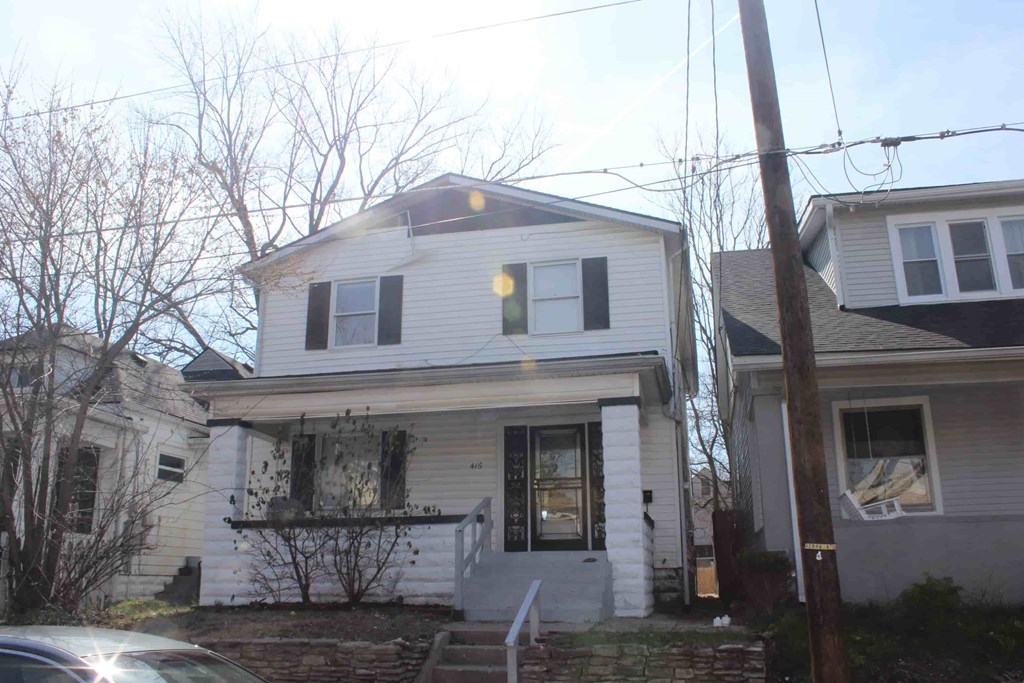 a white house with a car parked in front of it