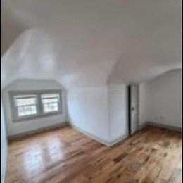 an empty room with white walls and a window