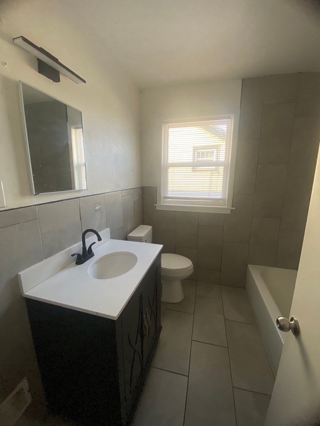 A bathroom with a sink, toilet, and bathtub.