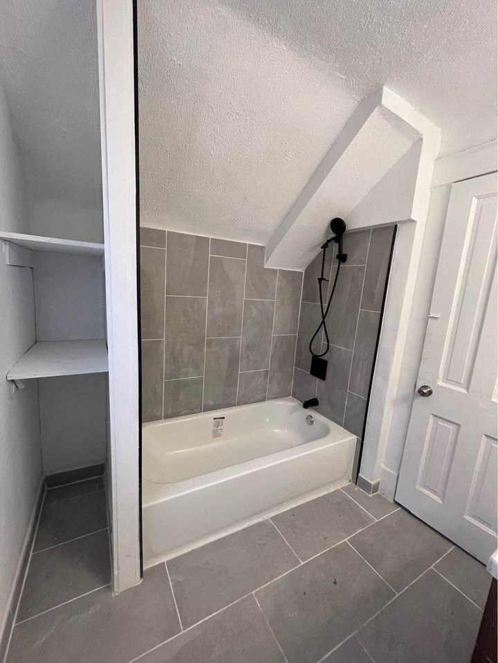 a bathroom with a bath tub and a closet