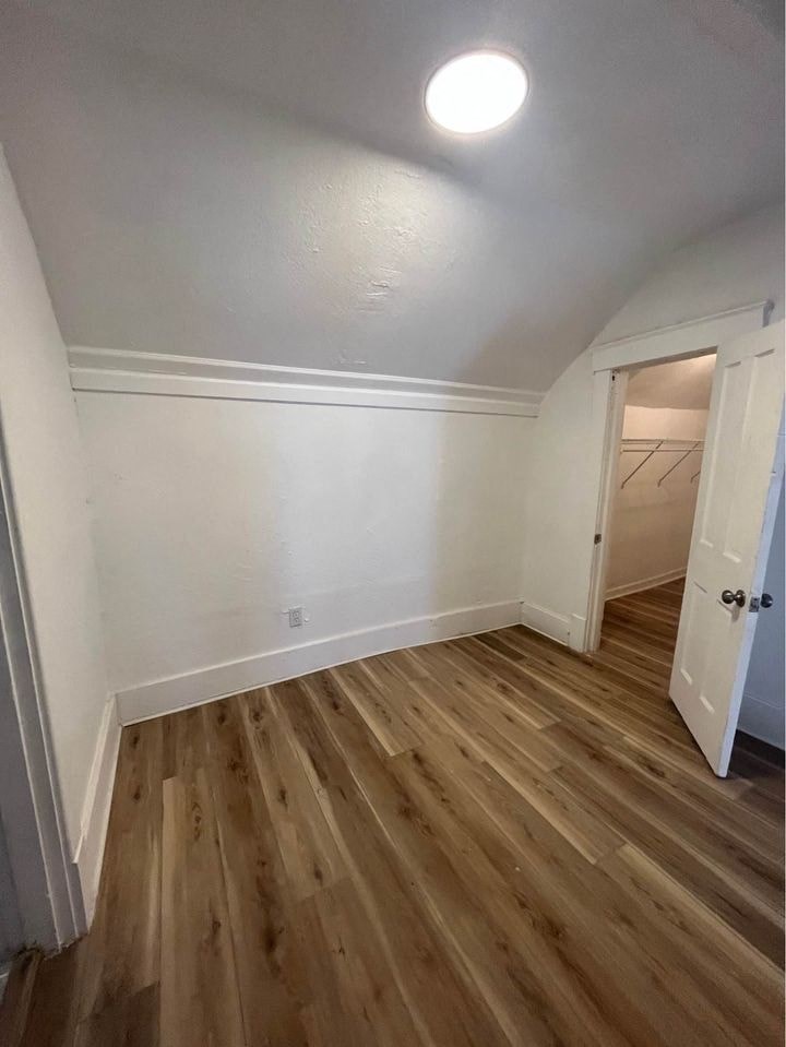 a living room with wooden floors and white walls