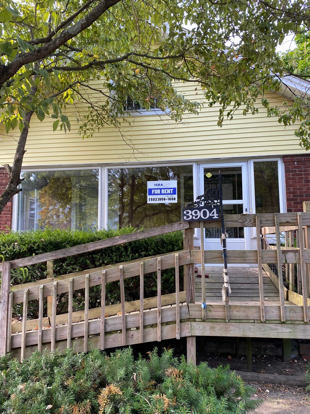 A yellow house with a sign that says "For Rent" and the number 3904.