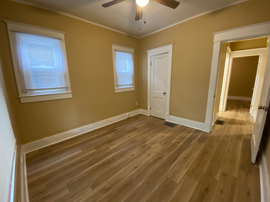 A room with wooden floors and a white door.