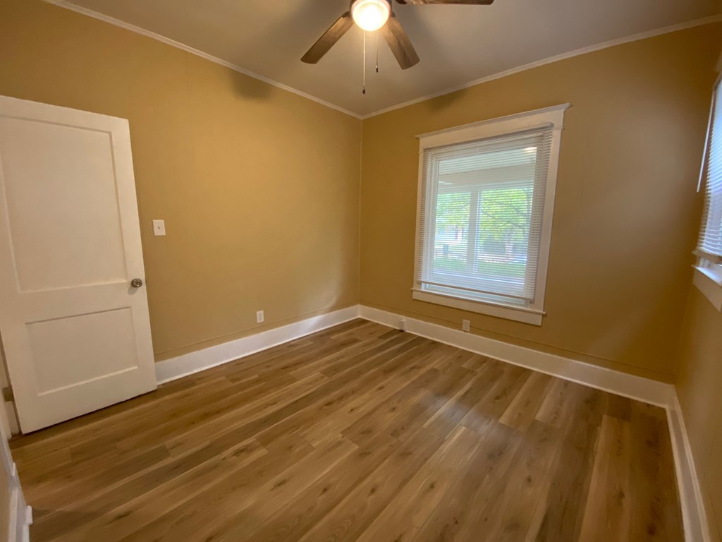 A room with a white door and a window with a white frame.
