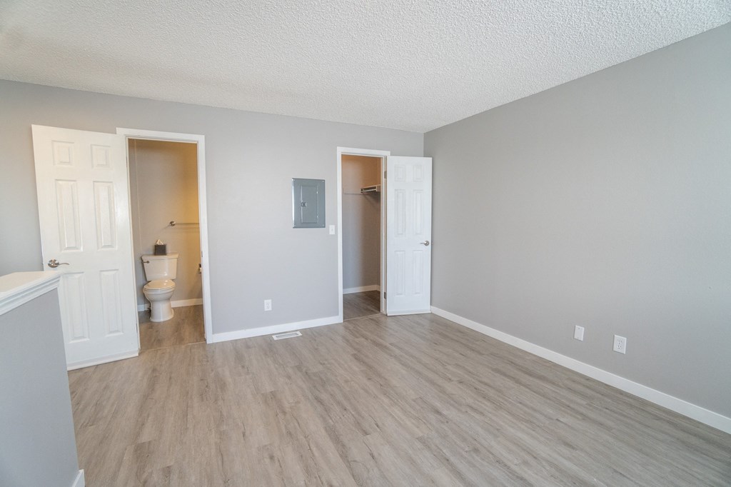an empty living room with a toilet and a bathroom