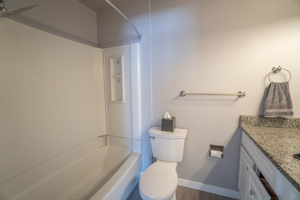 an empty bathroom with a toilet and a bath tub