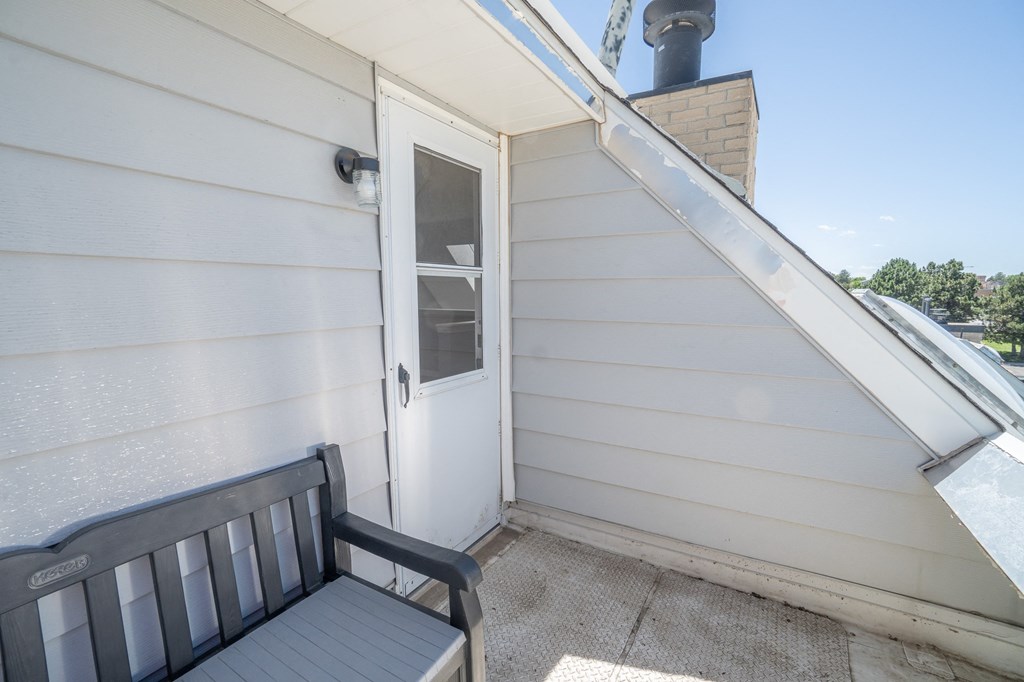 a front porch with a bench and a door