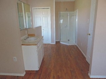 an empty bathroom with a sink and a door