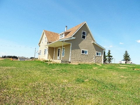 a house on a hill in a field