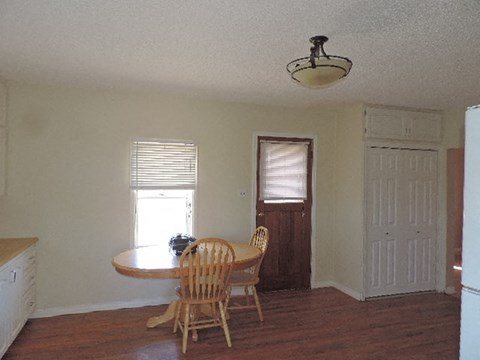a dining room with a table and chairs