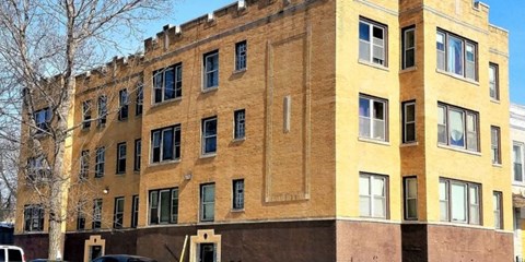 A large building with a yellow and brown facade.