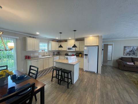 a view of a kitchen and dining area from the living room