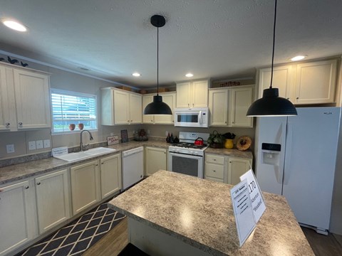 a kitchen with white cabinets and a counter top