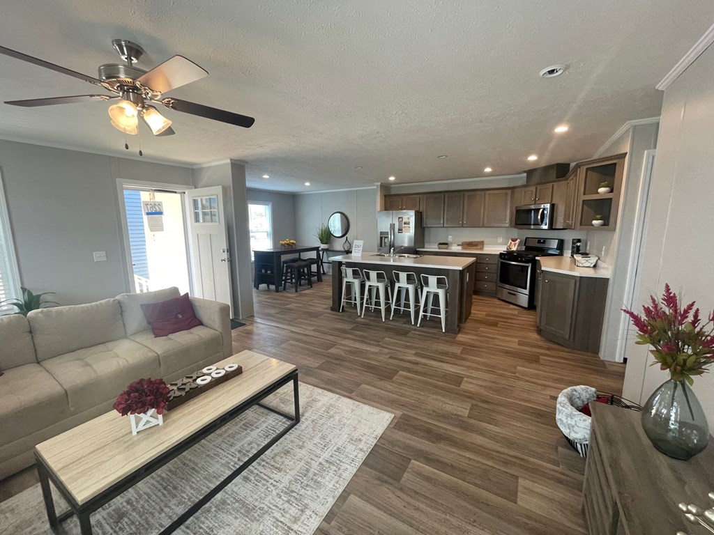 a living room and kitchen with a couch and a table