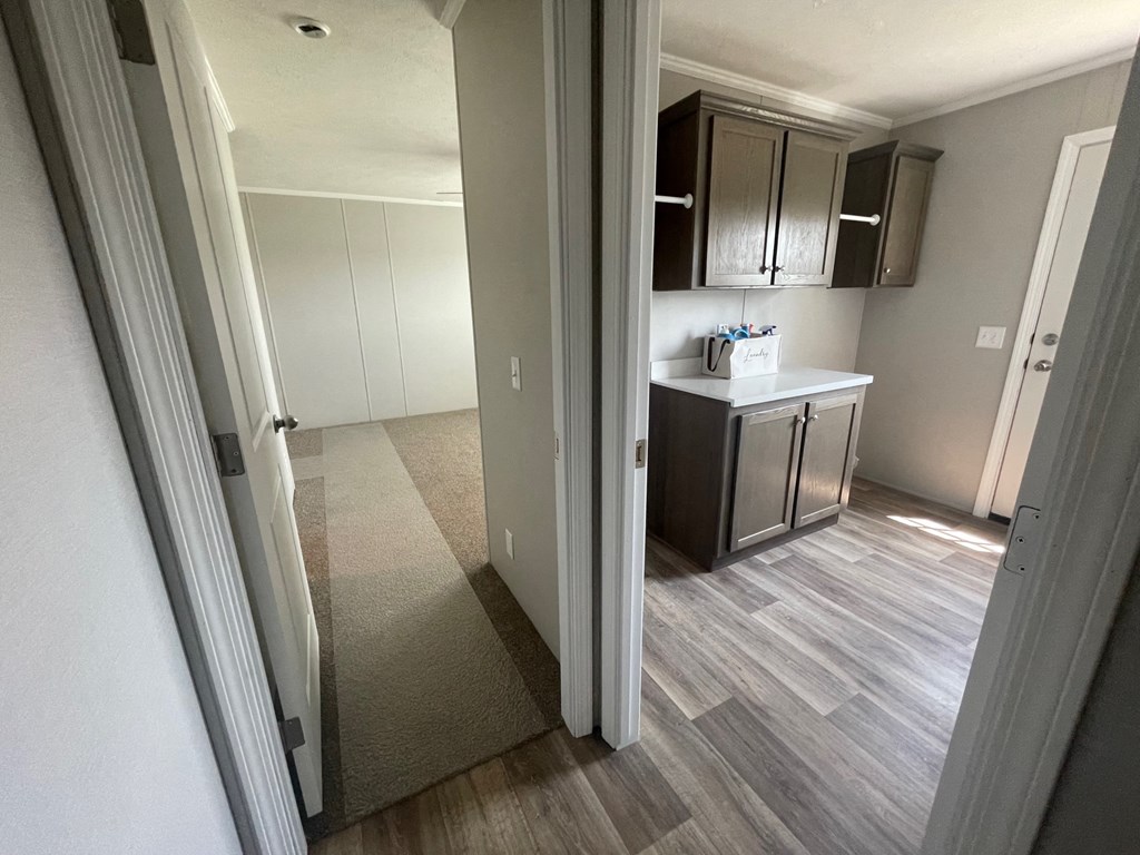 a view of a kitchen from the living room of an apartment