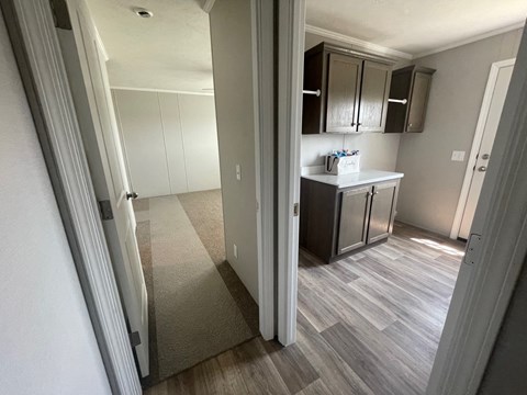 a view of a kitchen from the living room of an apartment