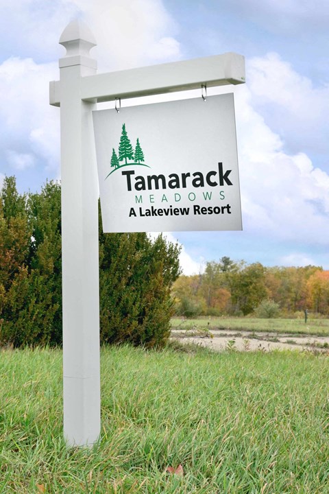 a sign for tamarack meadows a lakeview resort in a field
