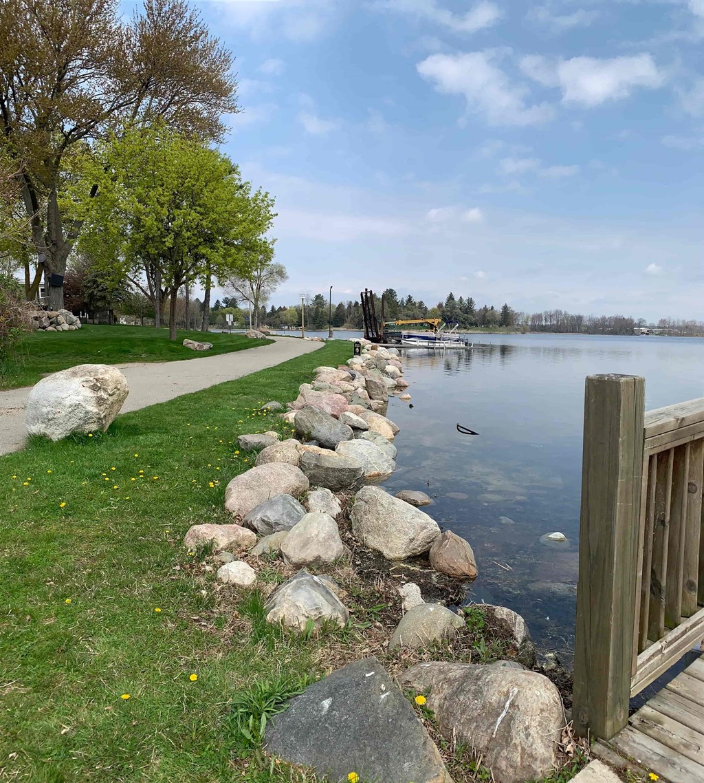 a path next to the water near a dock