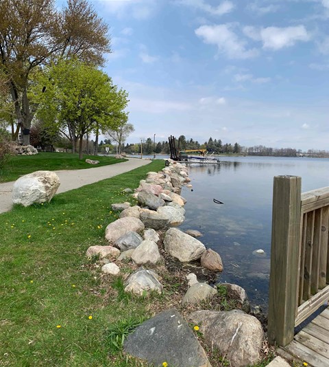 a path next to the water near a dock