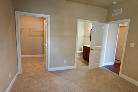 A room with a white door and a white fridge.