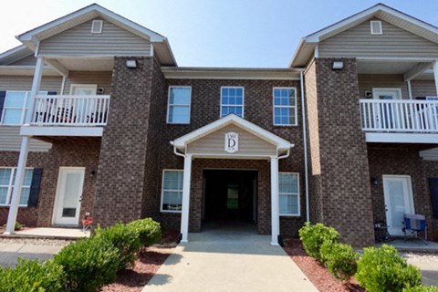 A building with a front entrance and a balcony.