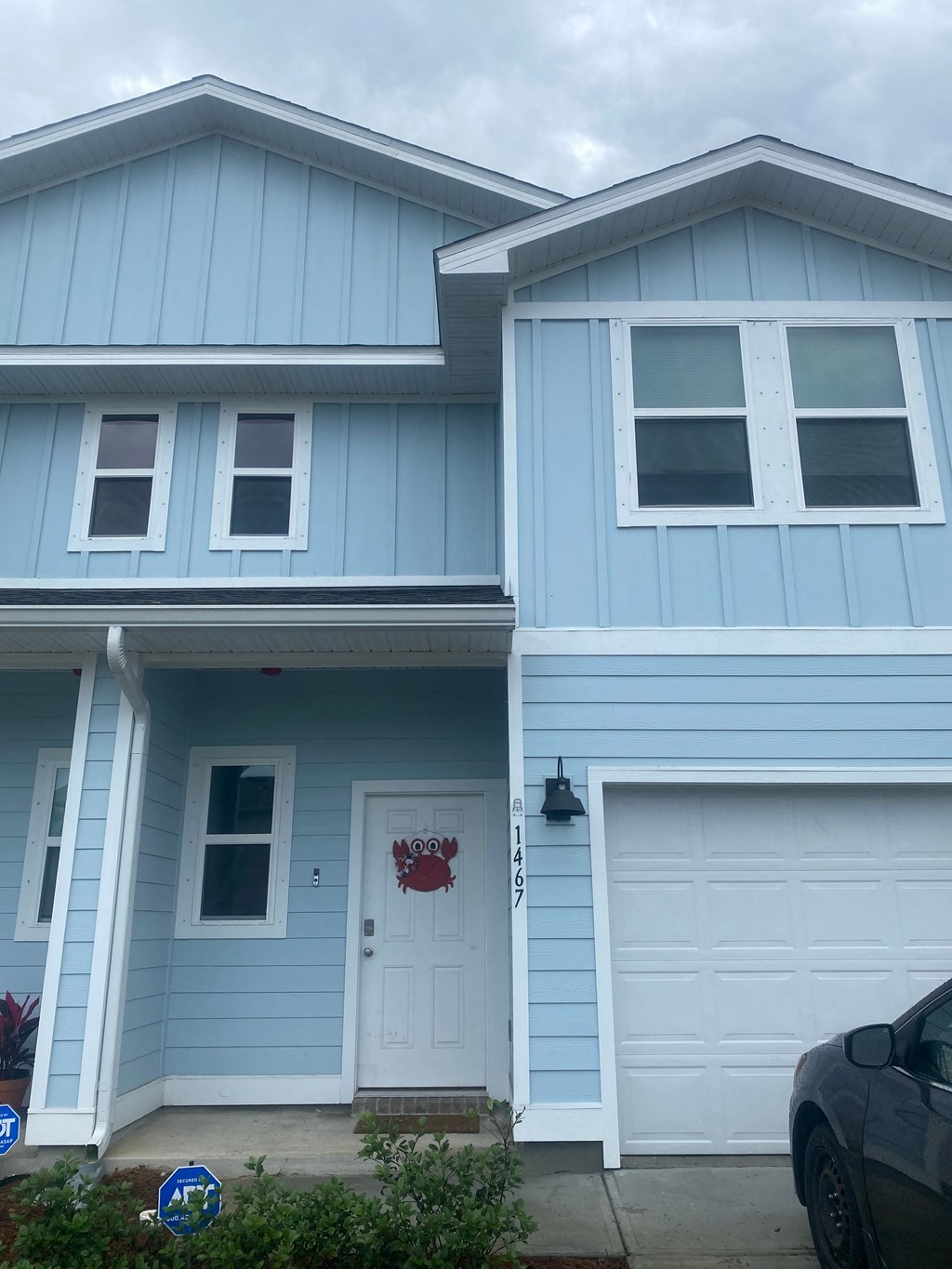 a blue house with a white garage door