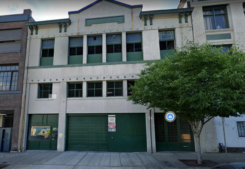 an old building with a tree in front of it