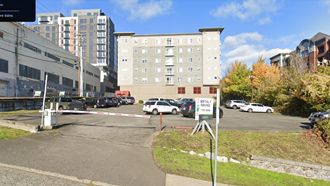 a parking lot with cars parked in front of a building