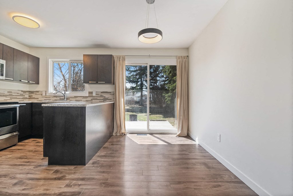 a kitchen with a sliding glass door leading to a patio