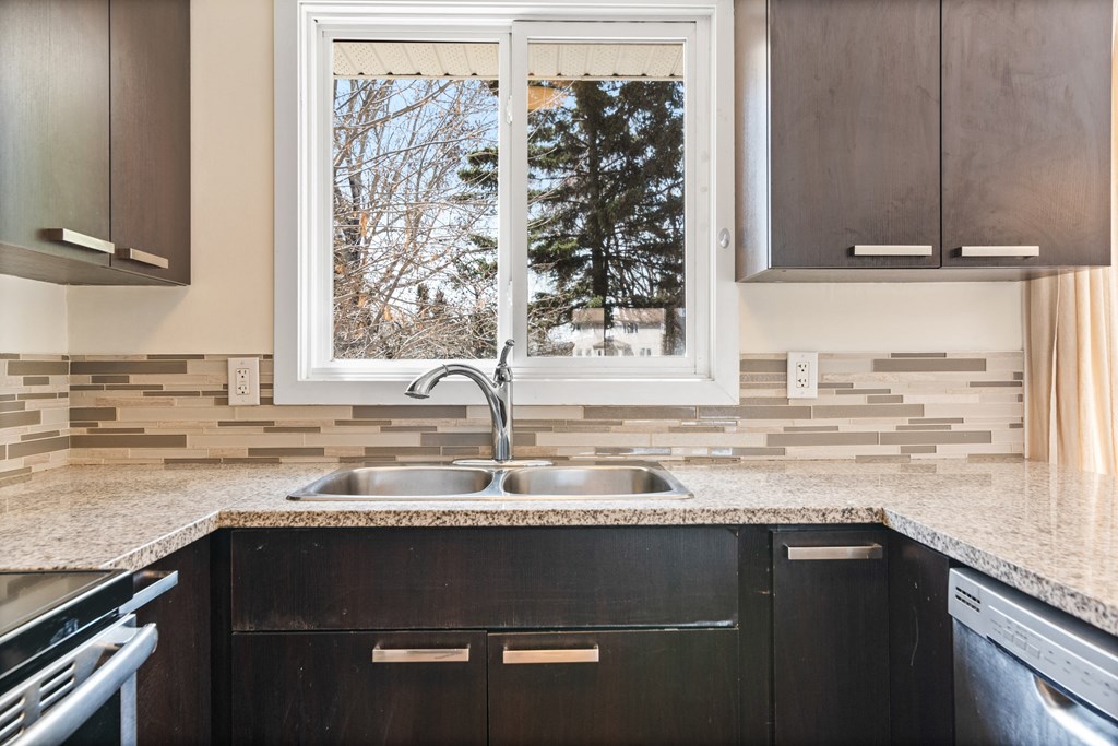 a kitchen with a sink and a window