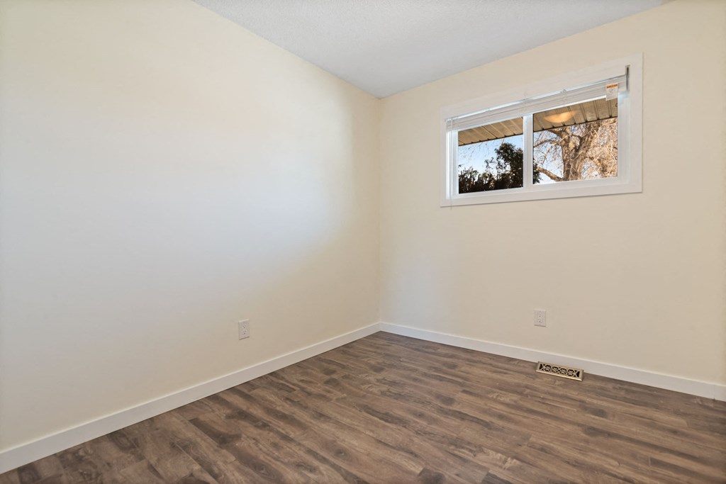 a living room with white walls and a window
