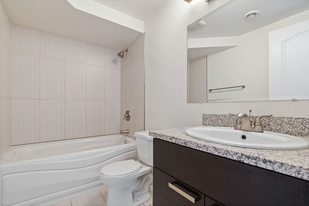 a bathroom with a sink and a toilet and a bath tub