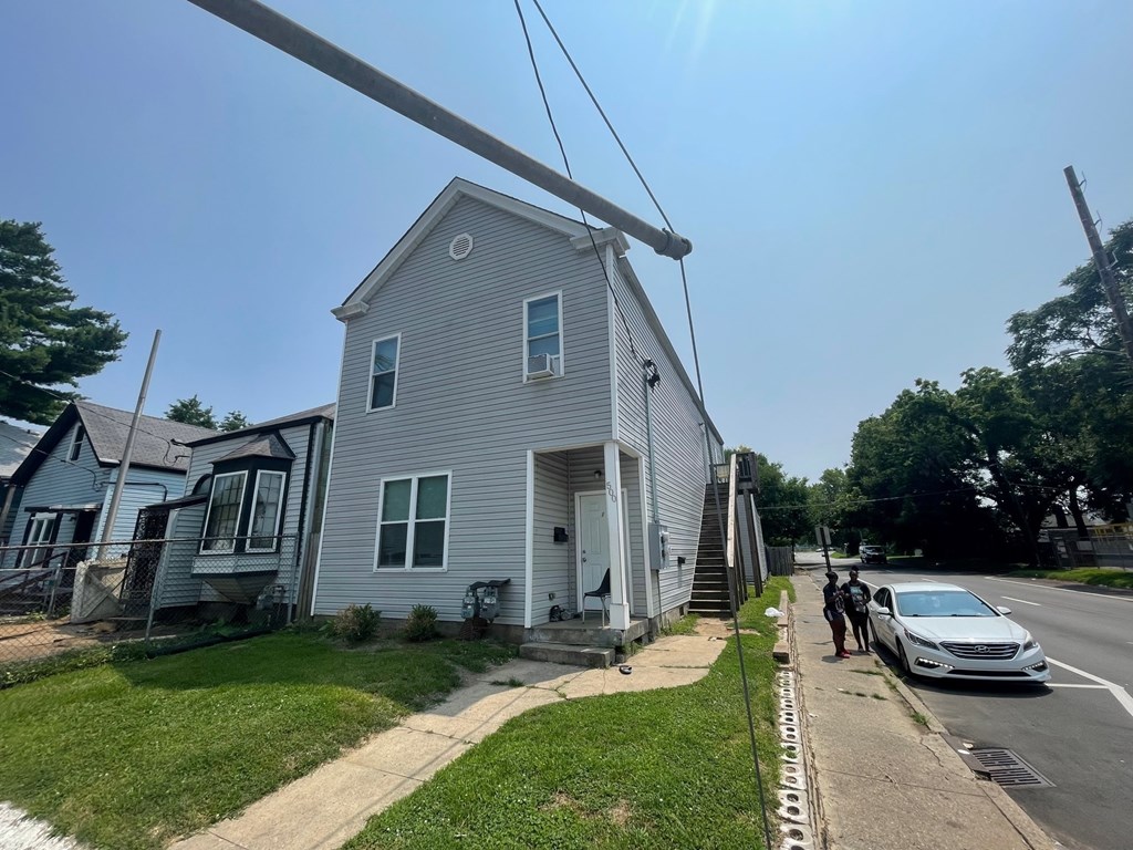 A house with a car parked in front of it.