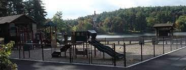 A playground with a slide and a fence.