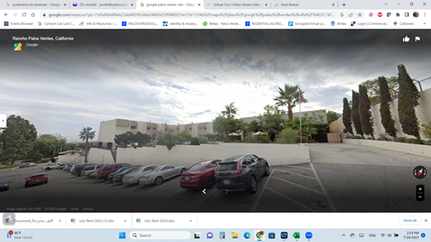 a screenshot of google street view of a parking lot with cars