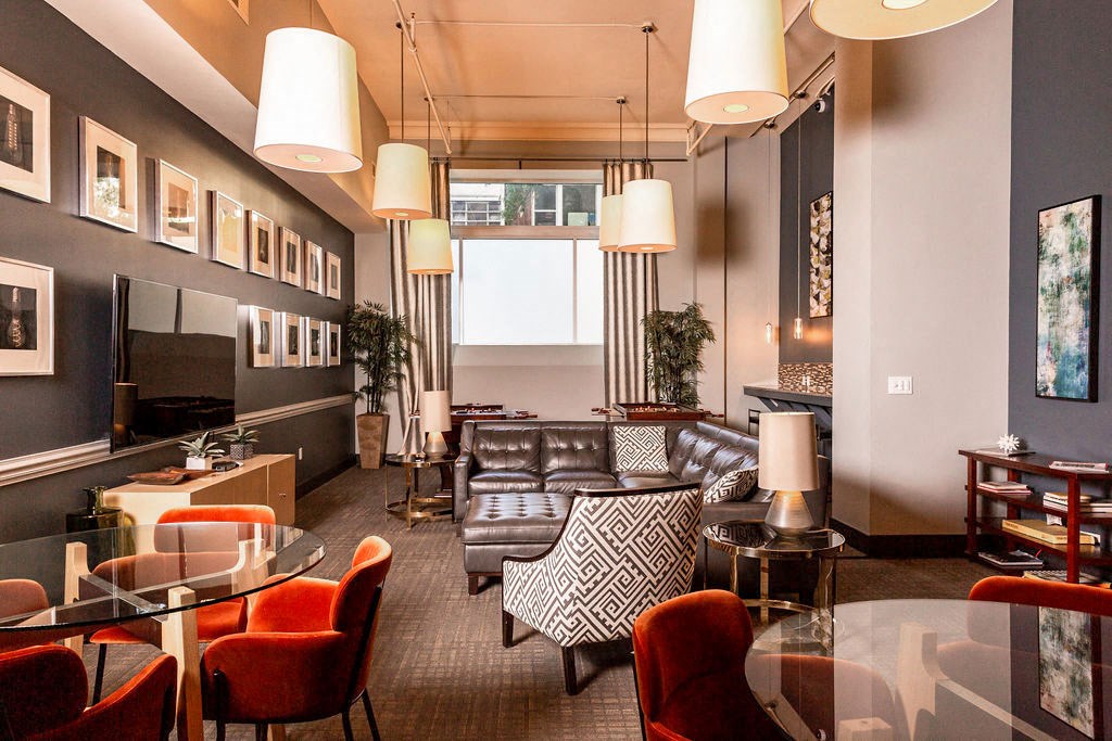 a living room with couches and chairs and a tv