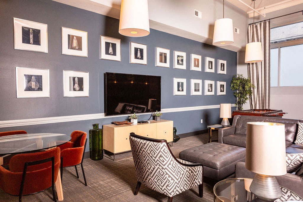 a living room with couches and chairs and a television