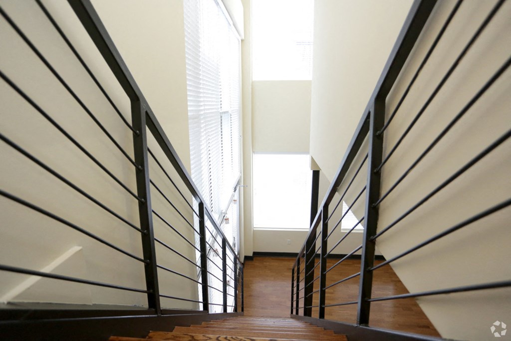 a view down the stairs of a house with a large window