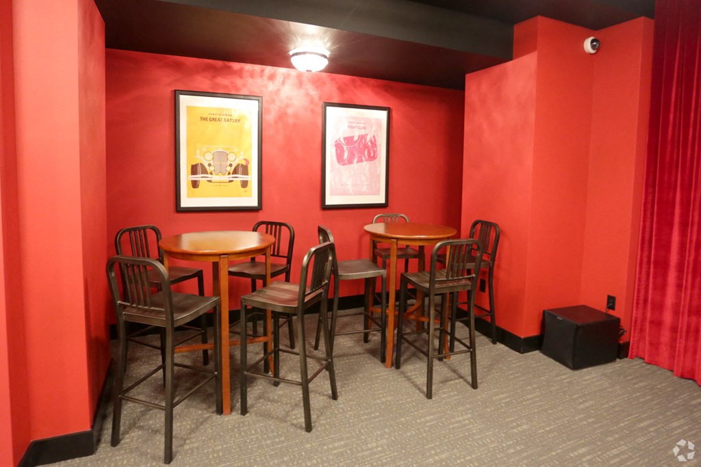 a dining room with red walls and tables and chairs