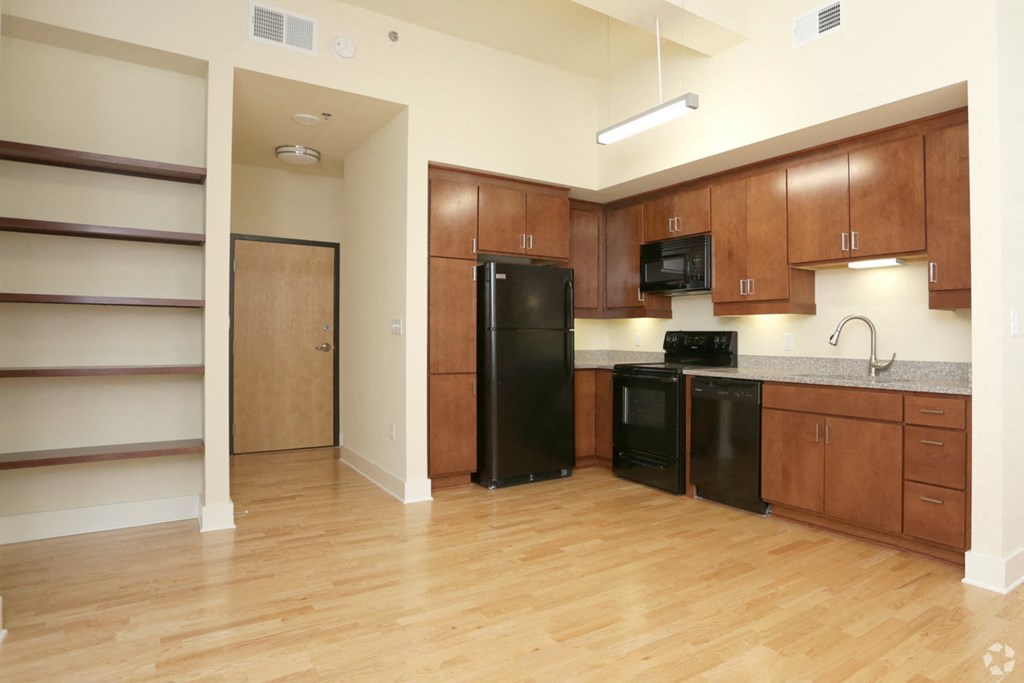 a kitchen with black appliances and wooden cabinets