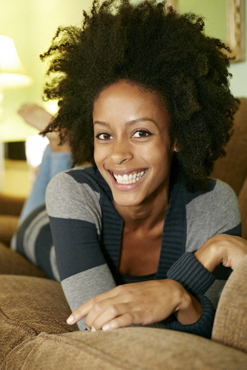 a woman laying on a couch with her arms crossed