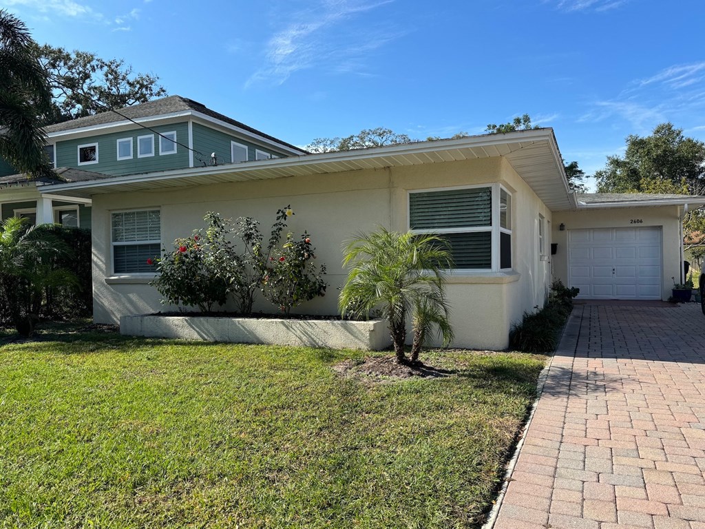 a small palm tree in front of a house