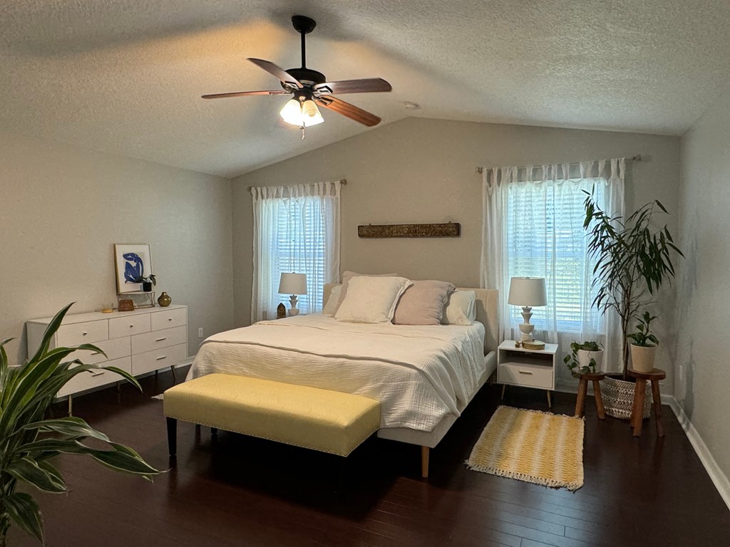 a bedroom with a bed and a ceiling fan