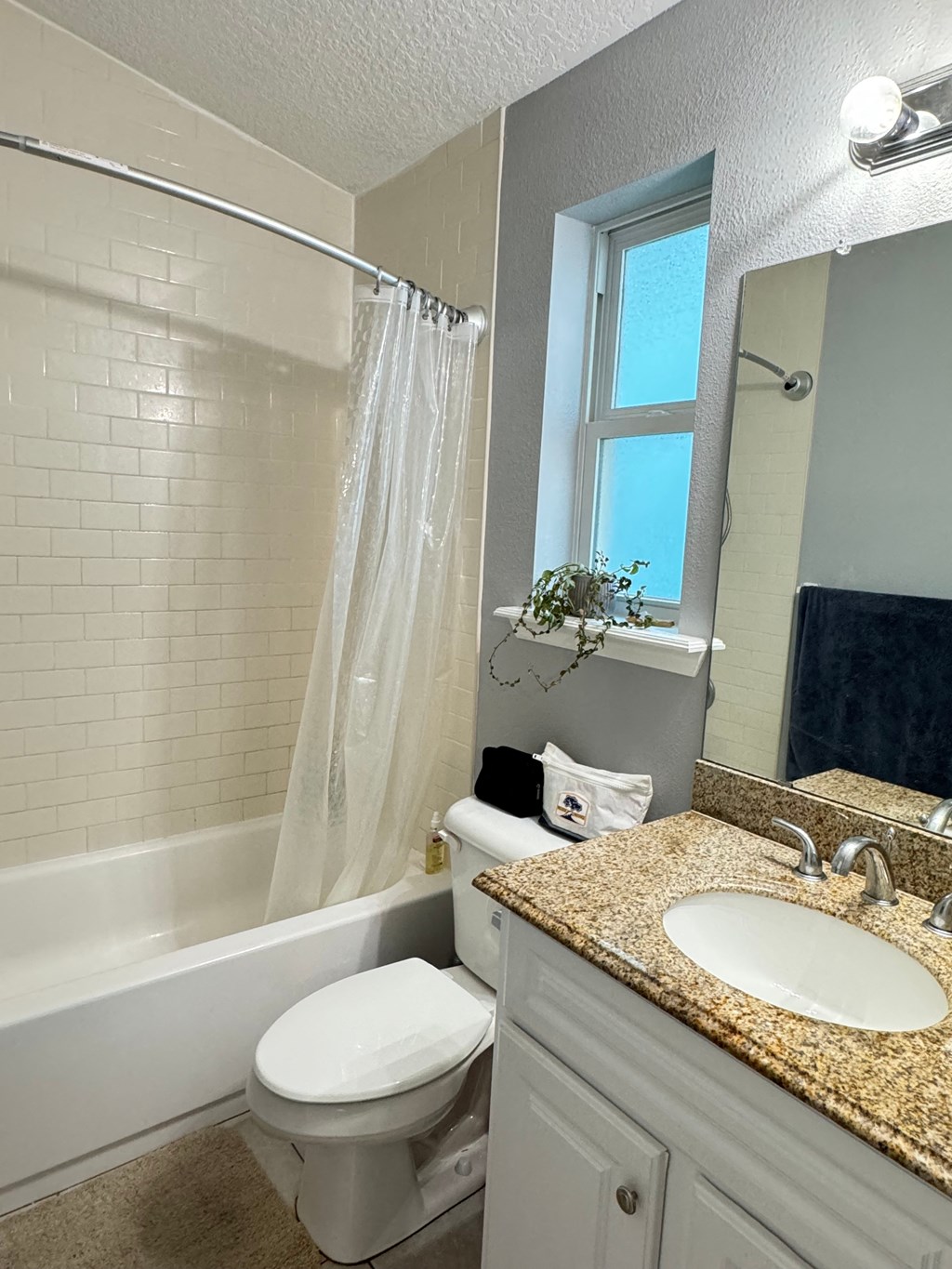 a bathroom with a toilet and a sink and a bath tub