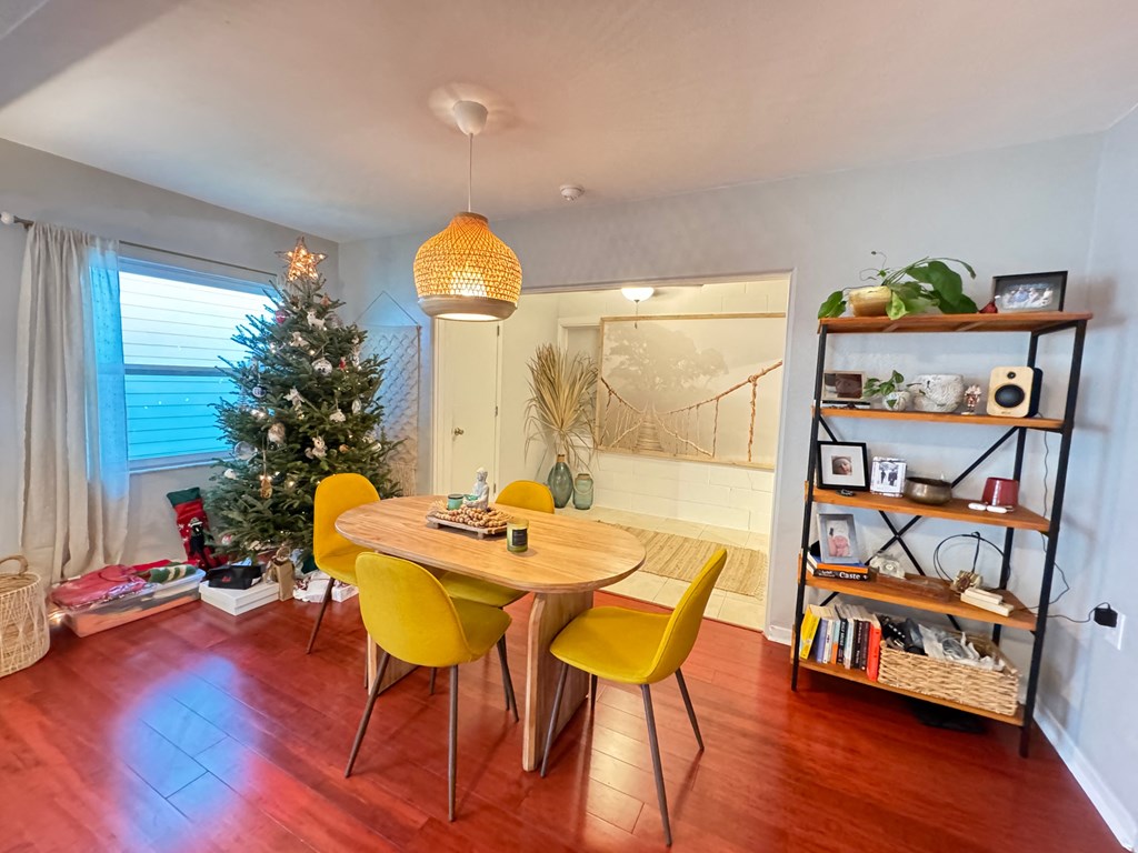 a dining room with a christmas tree and a table and chairs