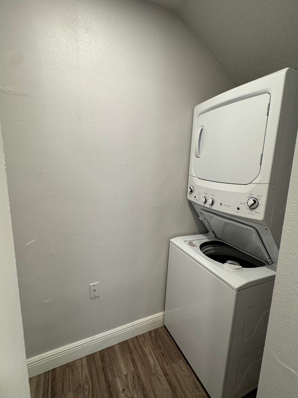 A white washing machine in a small room.