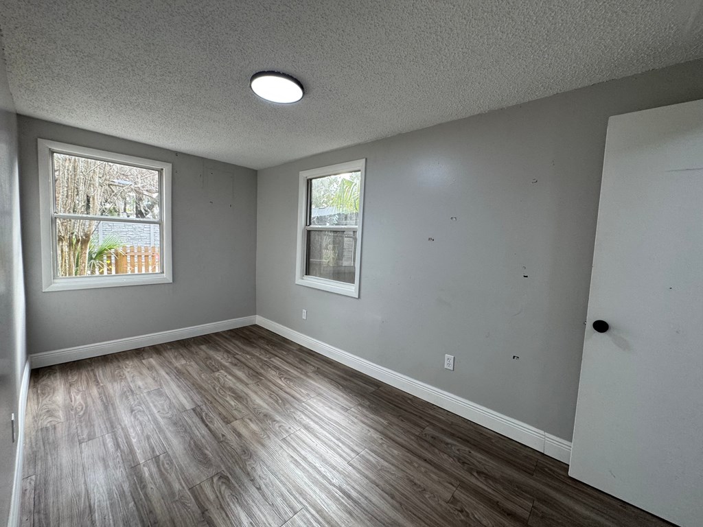 A room with a window and a door.